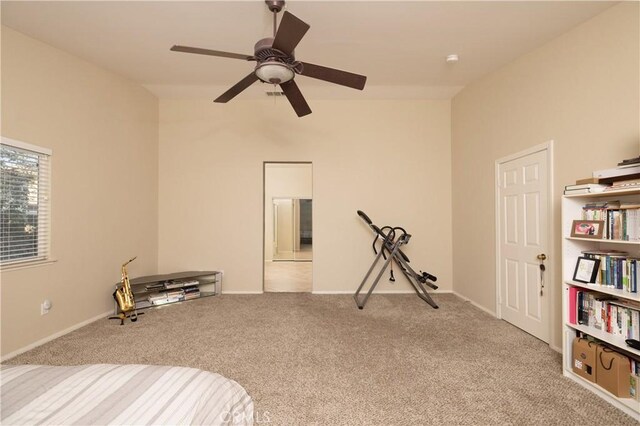 carpeted bedroom featuring baseboards and a ceiling fan