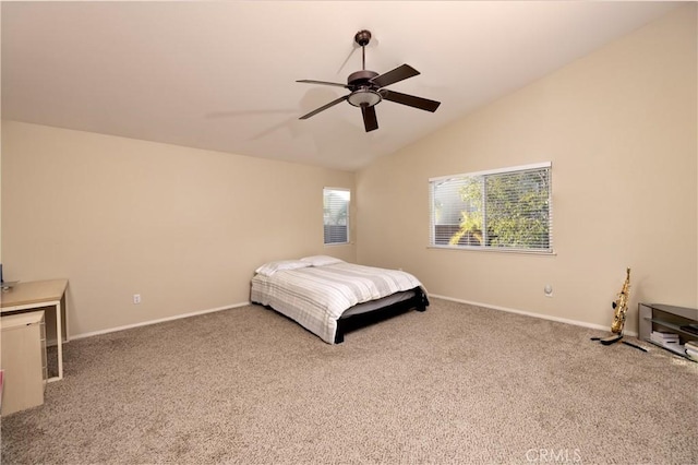 carpeted bedroom featuring lofted ceiling, baseboards, and a ceiling fan
