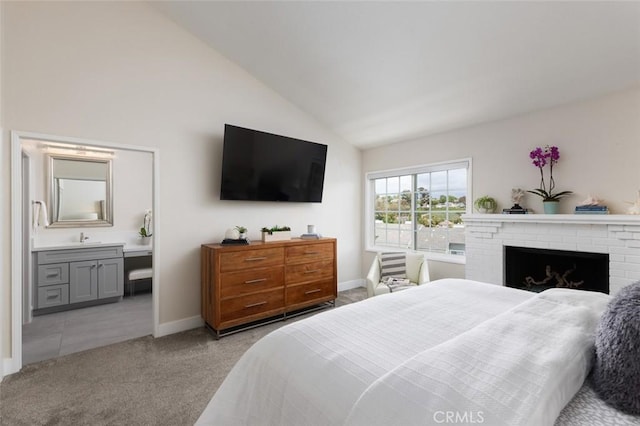 33156 Ocean Bright, Dana Point, CA 92629 - carpeted bedroom featuring vaulted ceiling, baseboards, connected bathroom, a sink, and a brick fireplace