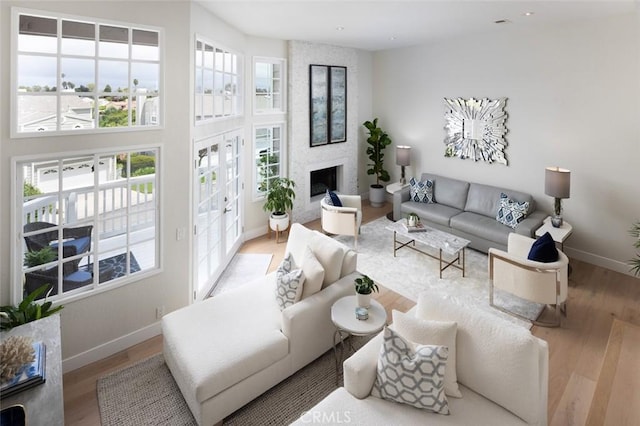 33156 Ocean Bright, Dana Point, CA 92629 - living room with wood finished floors, baseboards, and a large fireplace
