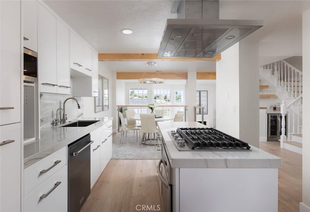 33156 Ocean Bright, Dana Point, CA 92629 - kitchen with appliances with stainless steel finishes, a sink, light wood-style flooring, light countertops, and a kitchen island