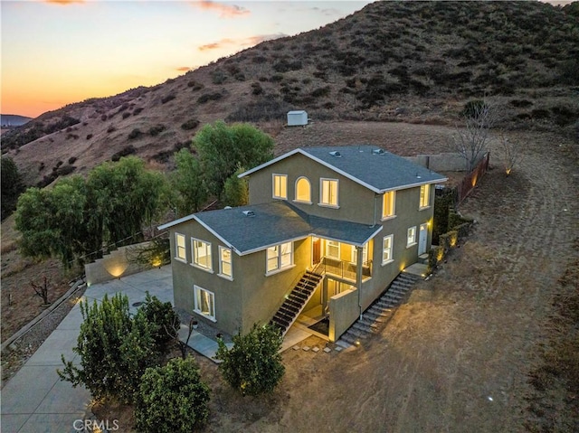 28637 Chiquito Canyon Rd, Castaic, CA 91384 - back of house with stucco siding, stairway, concrete driveway, a mountain view, and roof with shingles