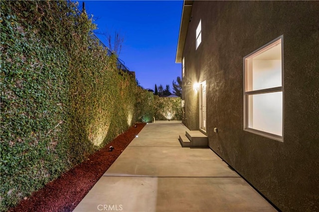28637 Chiquito Canyon Rd, Castaic, CA 91384 - view of side of home featuring stucco siding, a patio, and a fenced backyard