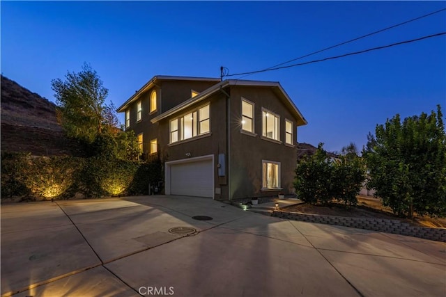 28637 Chiquito Canyon Rd, Castaic, CA 91384 - view of side of property featuring an attached garage, driveway, and stucco siding