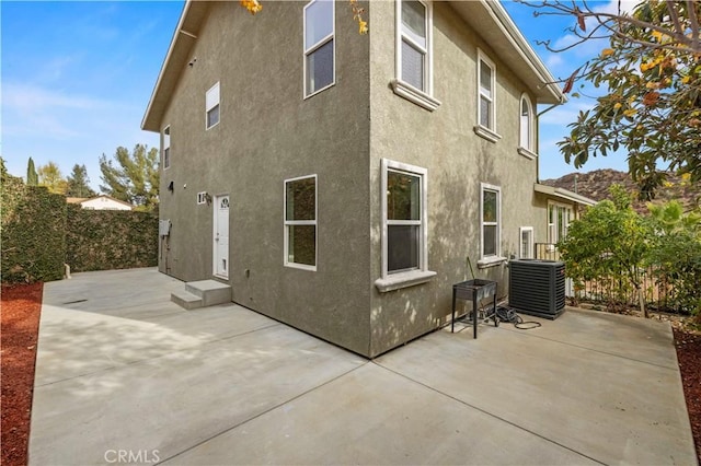28637 Chiquito Canyon Rd, Castaic, CA 91384 - back of house featuring central AC unit, stucco siding, a patio, and fence