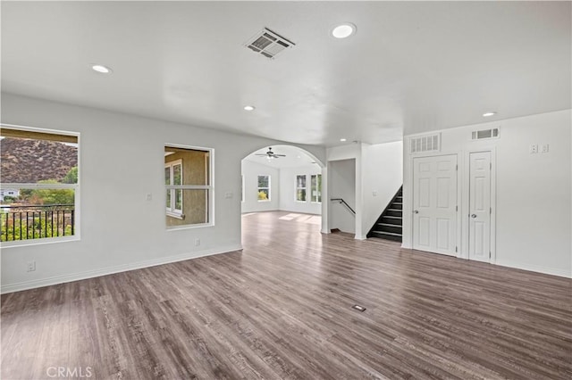 28637 Chiquito Canyon Rd, Castaic, CA 91384 - unfurnished living room with stairs, wood finished floors, baseboards, recessed lighting, and arched walkways
