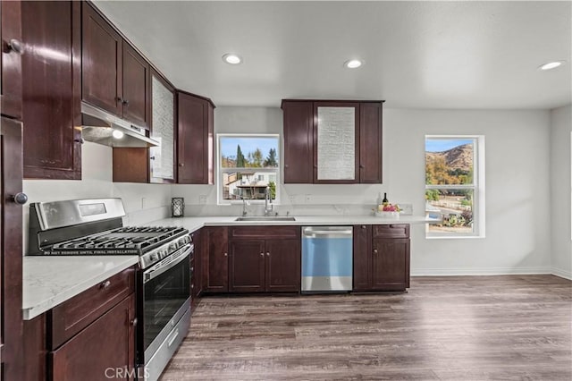 28637 Chiquito Canyon Rd, Castaic, CA 91384 - kitchen with appliances with stainless steel finishes, under cabinet range hood, a sink, dark wood finished floors, and recessed lighting