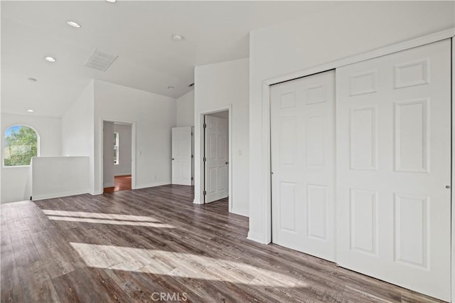 28637 Chiquito Canyon Rd, Castaic, CA 91384 - unfurnished bedroom with wood finished floors, a closet, vaulted ceiling, baseboards, and recessed lighting