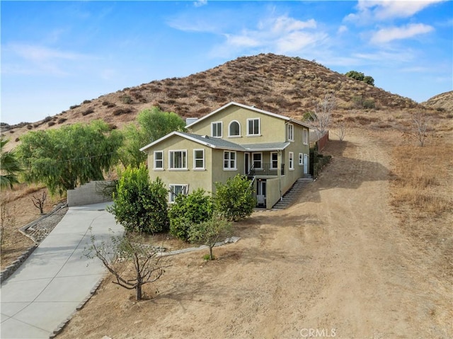 28637 Chiquito Canyon Rd, Castaic, CA 91384 - traditional-style home with concrete driveway, stucco siding, and a mountain view