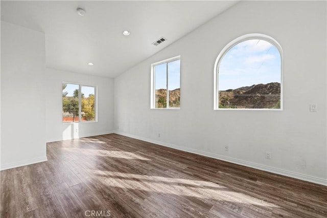 28637 Chiquito Canyon Rd, Castaic, CA 91384 - spare room with plenty of natural light, vaulted ceiling, wood finished floors, baseboards, and a smoke detector