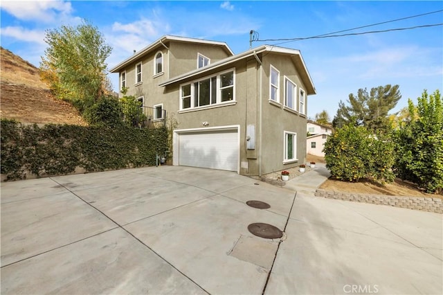 28637 Chiquito Canyon Rd, Castaic, CA 91384 - view of side of property featuring a garage, stucco siding, and driveway