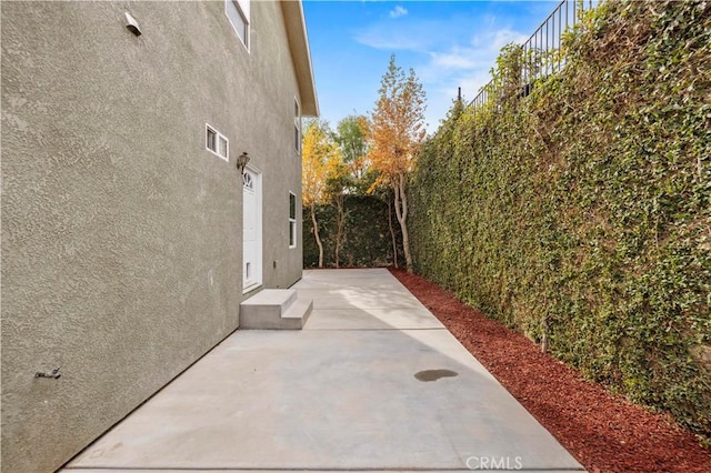 28637 Chiquito Canyon Rd, Castaic, CA 91384 - view of home's exterior with stucco siding, a patio, and fence