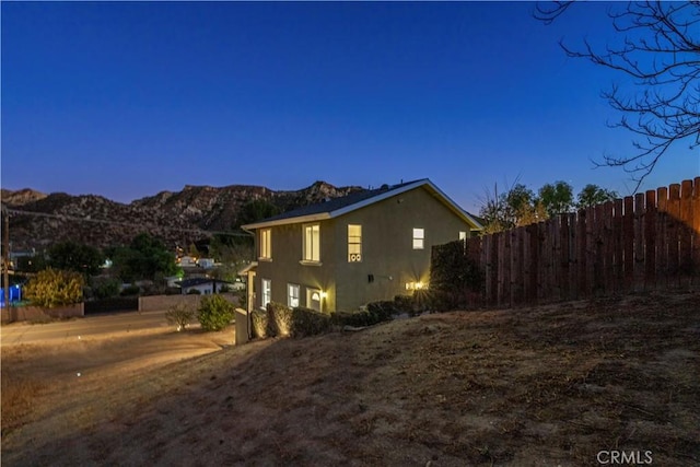 28637 Chiquito Canyon Rd, Castaic, CA 91384 - view of side of property with fence, a mountain view, and stucco siding