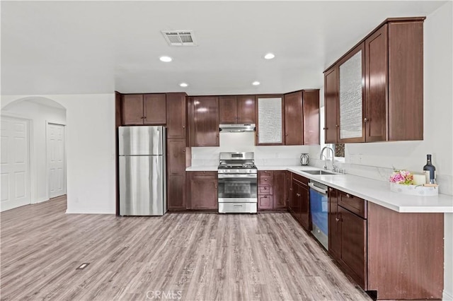 28637 Chiquito Canyon Rd, Castaic, CA 91384 - kitchen with stainless steel appliances, a sink, light wood-style floors, arched walkways, and recessed lighting