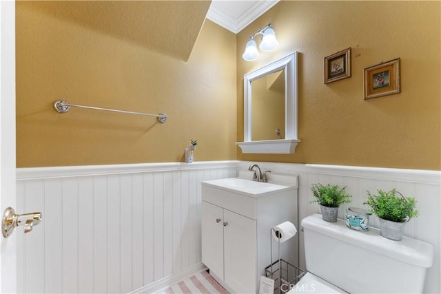 27952 Agapanthus Ln, Valencia, CA 91354 - half bathroom featuring wainscoting, vanity, toilet, and ornamental molding