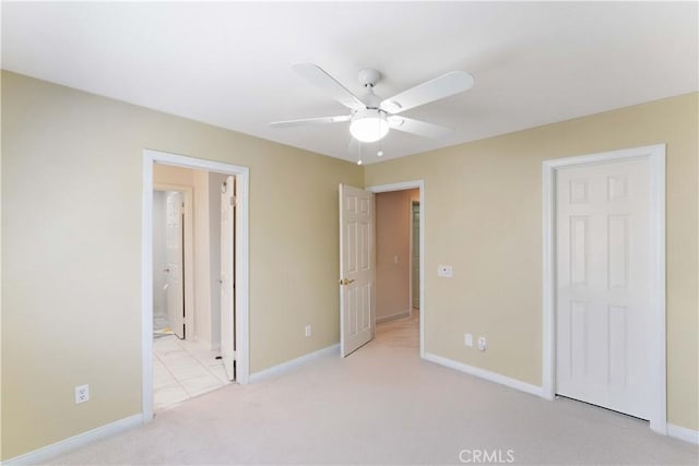 27952 Agapanthus Ln, Valencia, CA 91354 - unfurnished bedroom with light colored carpet, baseboards, connected bathroom, and ceiling fan