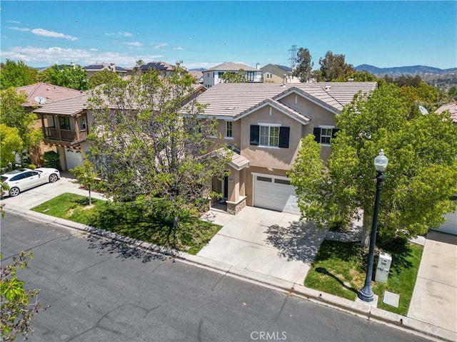 27952 Agapanthus Ln, Valencia, CA 91354 - view of front of property with an attached garage, driveway, stucco siding, and a tiled roof