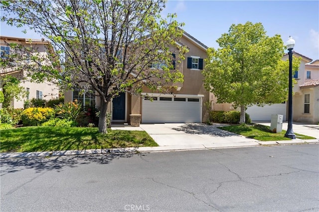 27952 Agapanthus Ln, Valencia, CA 91354 - obstructed view of property featuring stucco siding, concrete driveway, and an attached garage
