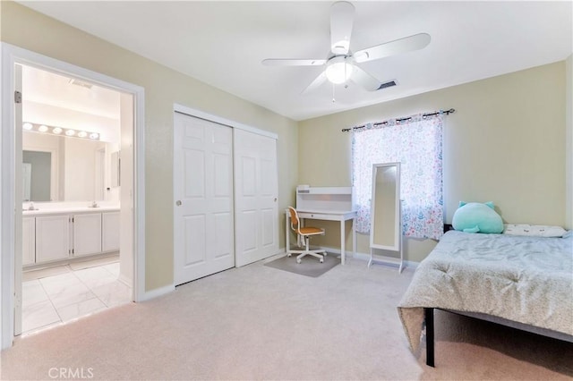 27952 Agapanthus Ln, Valencia, CA 91354 - bedroom with a closet, baseboards, ensuite bathroom, ceiling fan, and light colored carpet