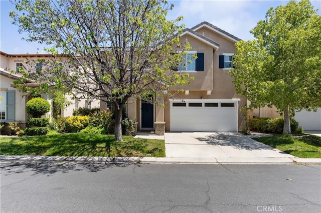 27952 Agapanthus Ln, Valencia, CA 91354 - view of front of house with stucco siding, concrete driveway, and a garage