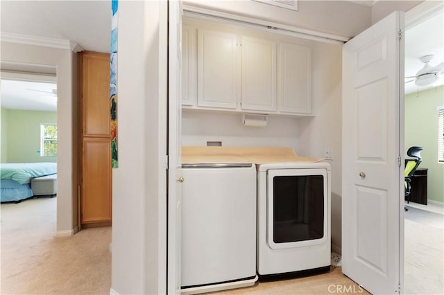 27952 Agapanthus Ln, Valencia, CA 91354 - clothes washing area with washer and dryer, cabinet space, light colored carpet, baseboards, and ornamental molding