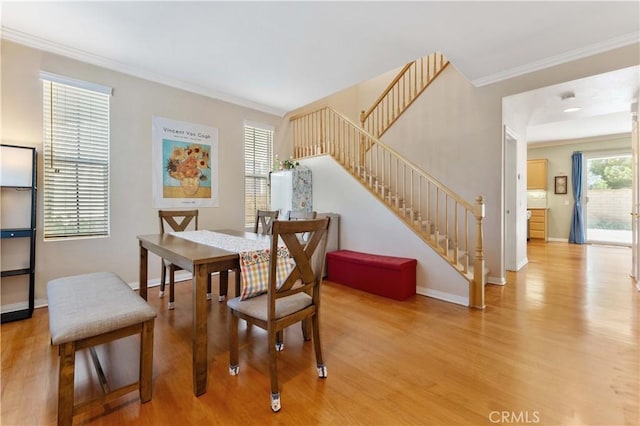 27952 Agapanthus Ln, Valencia, CA 91354 - dining area with light wood-type flooring, stairs, ornamental molding, and baseboards
