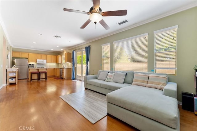 27952 Agapanthus Ln, Valencia, CA 91354 - living room featuring crown molding, ceiling fan, light wood-type flooring, recessed lighting, and baseboards