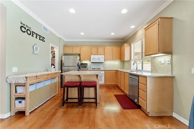 27952 Agapanthus Ln, Valencia, CA 91354 - kitchen featuring stainless steel appliances, light brown cabinets, light countertops, crown molding, and a sink