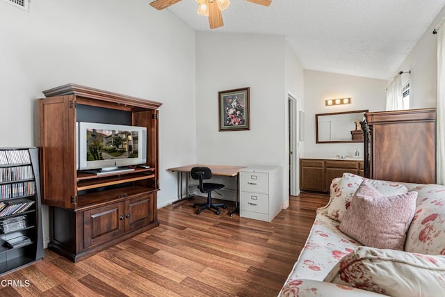 office area featuring lofted ceiling, wood finished floors, a ceiling fan, and a textured ceiling