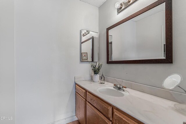 bathroom featuring vanity and a textured ceiling