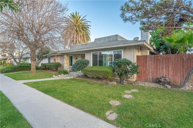 2726 W Orion Ave, Santa Ana, CA 92704 - view of front facade with a chimney, board and batten siding, and stone siding