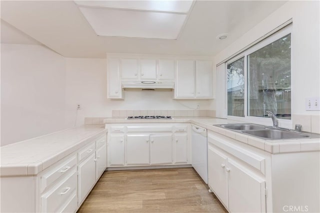 2726 W Orion Ave, Santa Ana, CA 92704 - kitchen featuring dishwasher, under cabinet range hood, a peninsula, gas cooktop, and tile counters