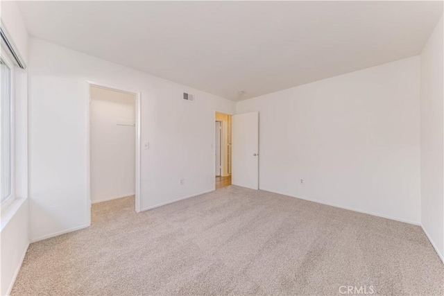 2726 W Orion Ave, Santa Ana, CA 92704 - unfurnished bedroom featuring carpet, a closet, and a walk in closet