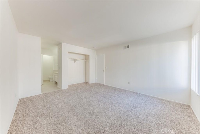 2726 W Orion Ave, Santa Ana, CA 92704 - unfurnished bedroom featuring light colored carpet, a closet, and ensuite bathroom