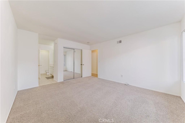 2726 W Orion Ave, Santa Ana, CA 92704 - unfurnished bedroom featuring light colored carpet, ensuite bath, and a closet