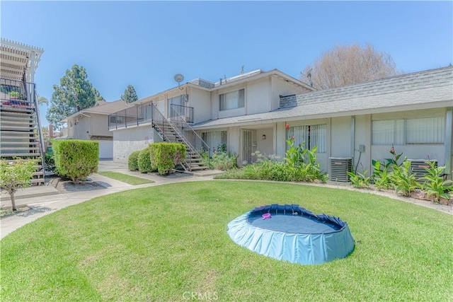 2726 W Orion Ave, Santa Ana, CA 92704 - rear view of property featuring stairway and a lawn