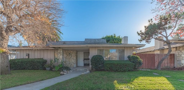 2726 W Orion Ave, Santa Ana, CA 92704 - view of front of house with a chimney, stone siding, and board and batten siding