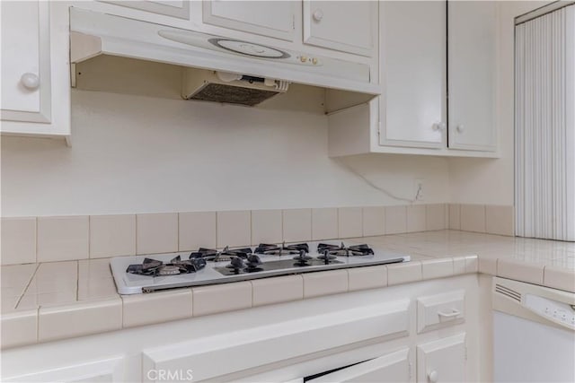 2726 W Orion Ave, Santa Ana, CA 92704 - kitchen featuring white appliances, under cabinet range hood, tile countertops, white cabinets, and decorative backsplash