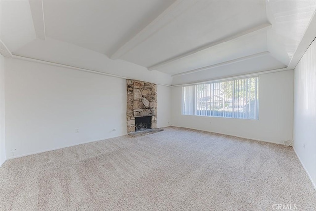 2726 W Orion Ave, Santa Ana, CA 92704 - unfurnished living room featuring carpet floors, beamed ceiling, and a stone fireplace
