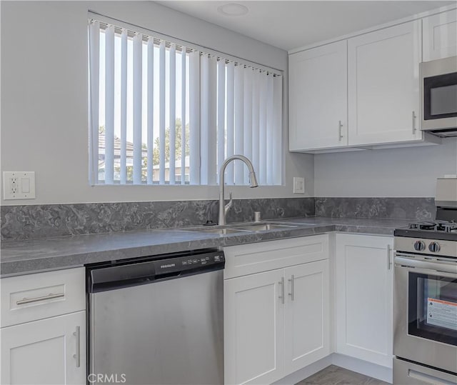 2726 W Orion Ave, Santa Ana, CA 92704 - kitchen featuring stainless steel appliances, white cabinetry, and dark countertops