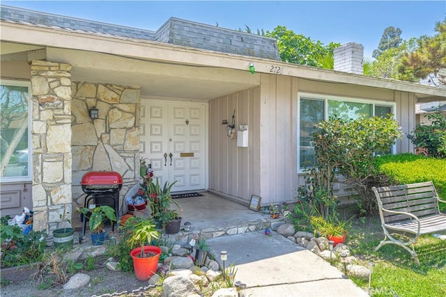 2726 W Orion Ave, Santa Ana, CA 92704 - view of exterior entry with stone siding and a chimney