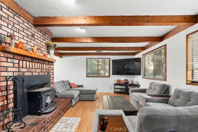 14177 Racine Cir, Magalia, CA 95954 - living room with a wood stove, beamed ceiling, and wood finished floors