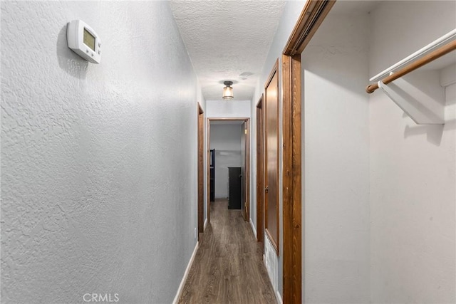 14177 Racine Cir, Magalia, CA 95954 - hallway featuring dark wood finished floors, a textured ceiling, and baseboards