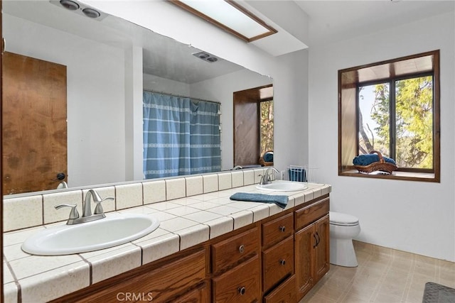 14177 Racine Cir, Magalia, CA 95954 - full bath with toilet, double vanity, tile patterned floors, and a shower with shower curtain