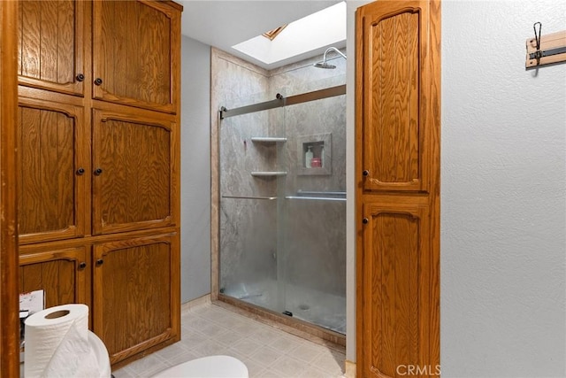 14177 Racine Cir, Magalia, CA 95954 - bathroom with a skylight, a shower stall, a textured wall, and tile patterned floors