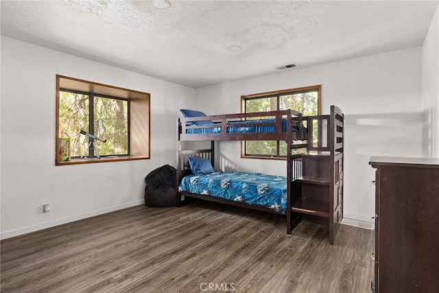 14177 Racine Cir, Magalia, CA 95954 - bedroom featuring wood finished floors, a textured ceiling, and baseboards