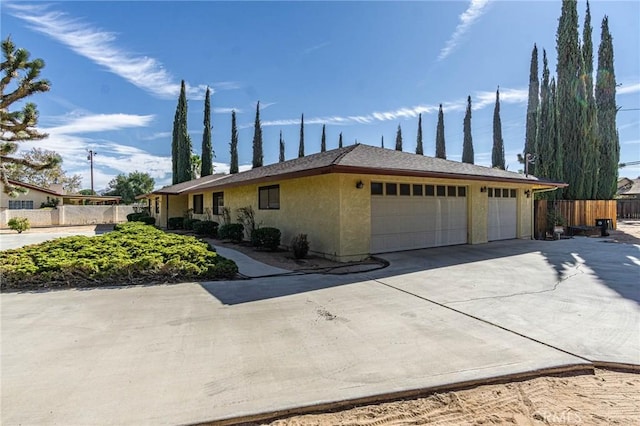 20407 Eyota Ln, Apple Valley, CA 92308 - view of front of property featuring fence, an attached garage, concrete driveway, and stucco siding