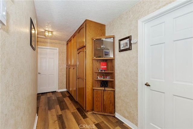 20407 Eyota Ln, Apple Valley, CA 92308 - corridor with dark wood-style flooring, a textured ceiling, and baseboards