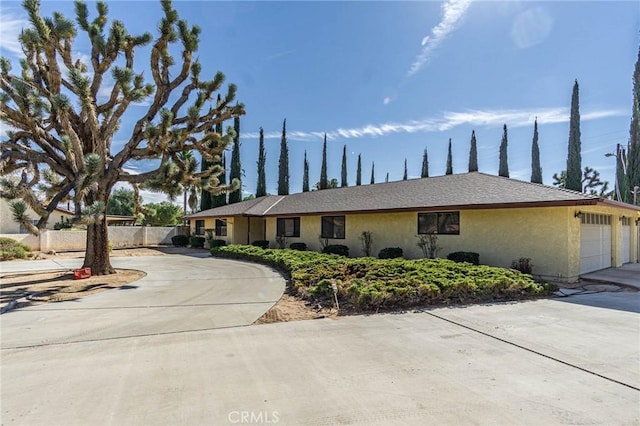 20407 Eyota Ln, Apple Valley, CA 92308 - view of front facade featuring concrete driveway, stucco siding, fence, and an attached garage
