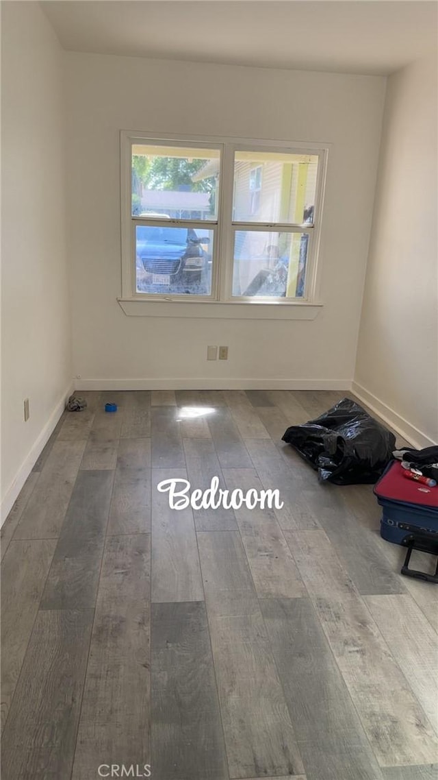 unfurnished room with hardwood / wood-style floors